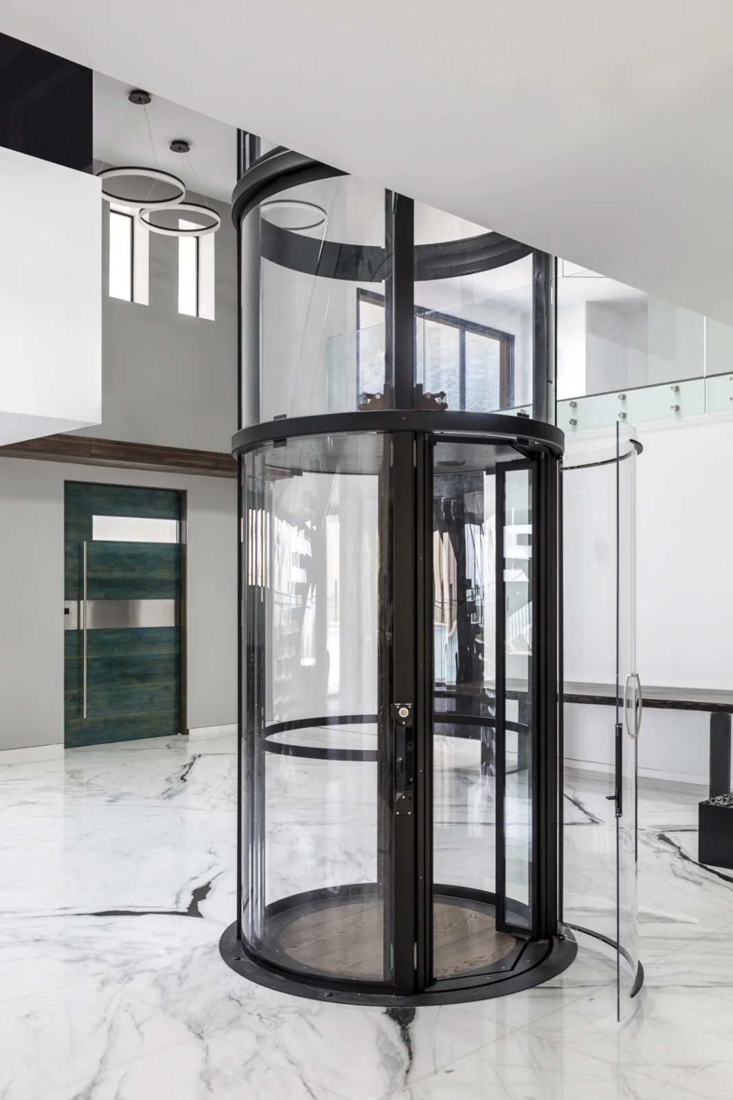 Savaria Vuelift Mini compact glass elevator installed next to staircase in home