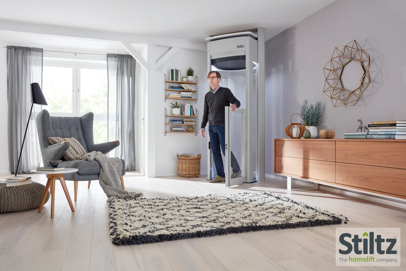 Savaria Vuelift panoramic glass home elevator in a modern open-concept living space